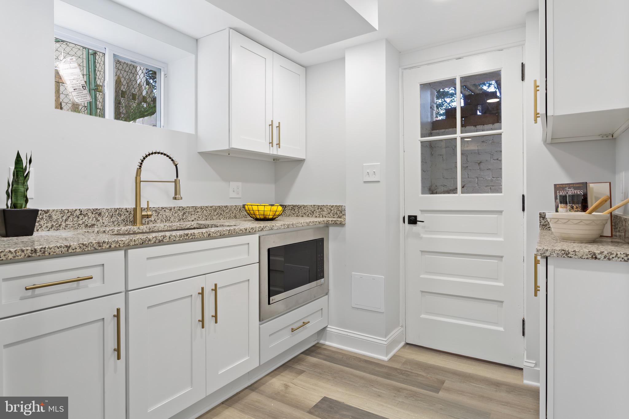 617 Greenbrier Drive Silver Spring, MD 20910 - Photo 54 of 70 a kitchen with granite countertop white cabinets and appliances