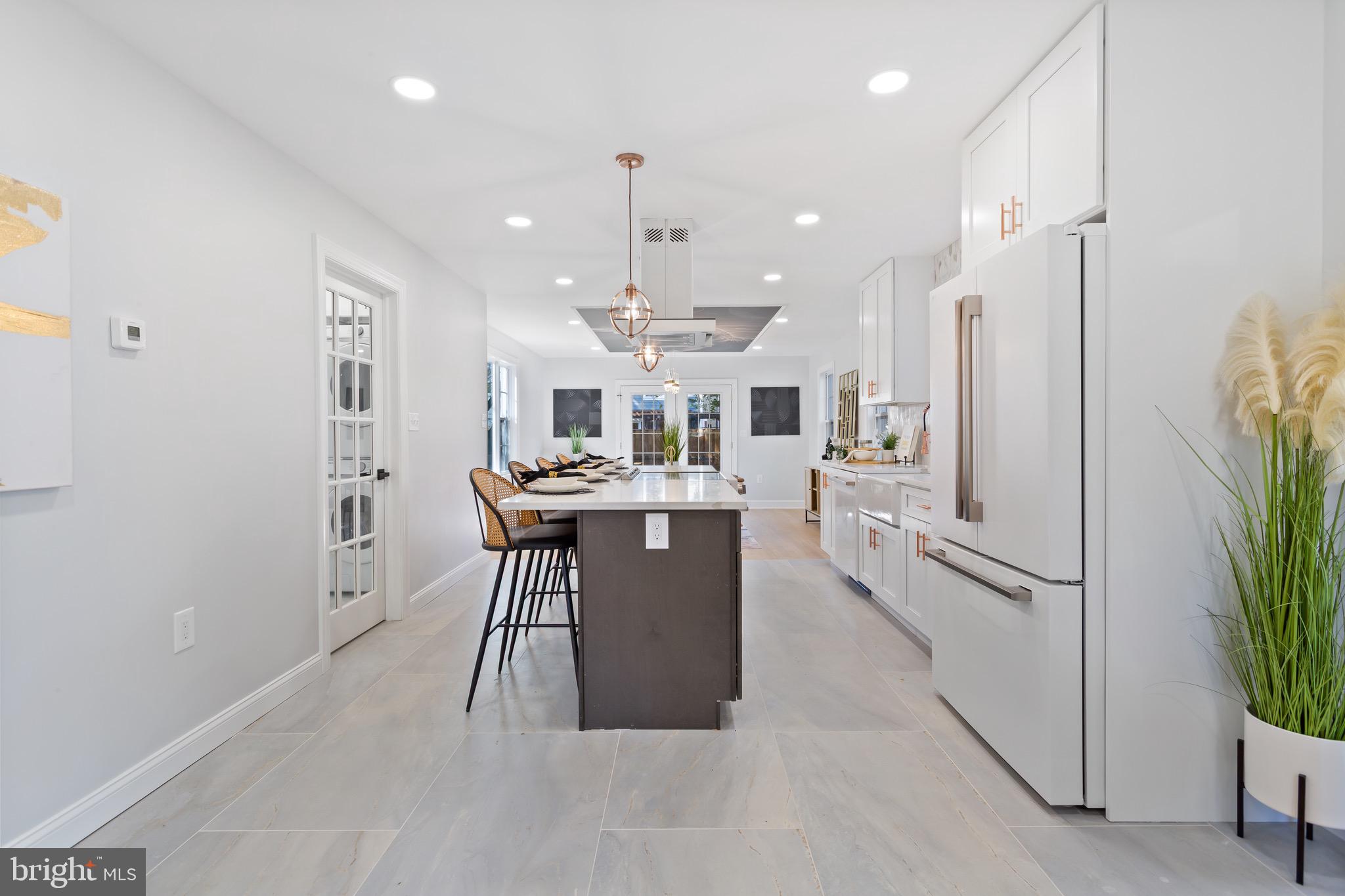 617 Greenbrier Drive Silver Spring, MD 20910 - Photo 9 of 70 a kitchen with stainless steel appliances kitchen island a refrigerator and a stove top oven