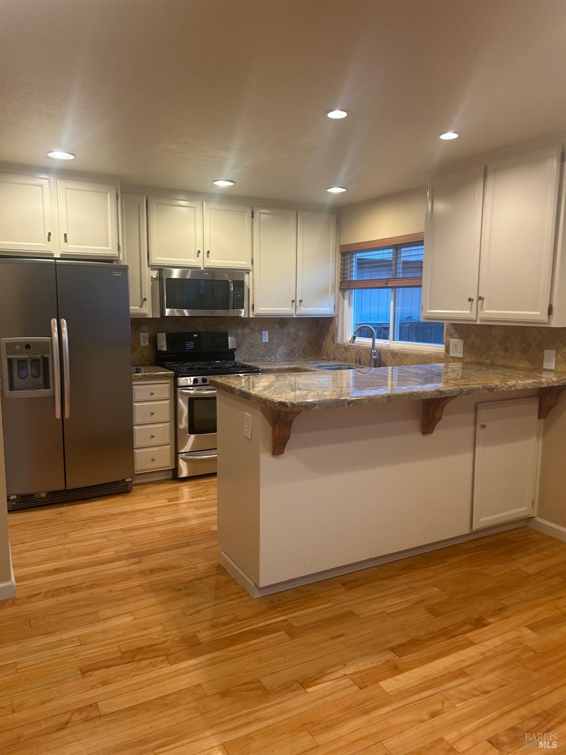 7536 Mercedes Way Rohnert Park, CA 94928 - Photo 2 of 11 a kitchen with stainless steel appliances granite countertop a sink a stove and a refrigerator