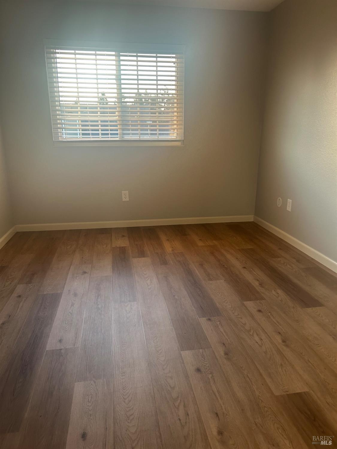 7536 Mercedes Way Rohnert Park, CA 94928 - Photo 7 of 11 an empty room with wooden floor and windows