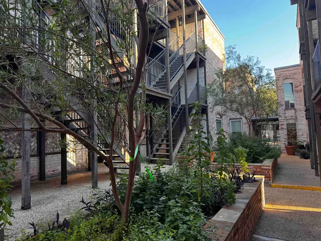 a view of a house with a tree beside it