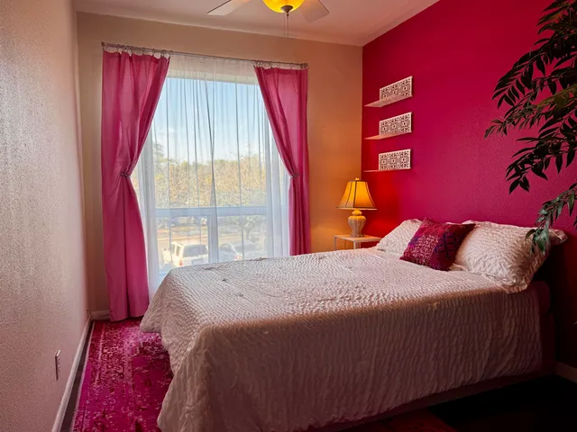 a bedroom with a bed and a window