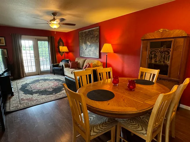 a dining room with furniture and wooden floor