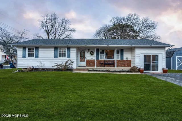 a front view of house with yard and outdoor seating