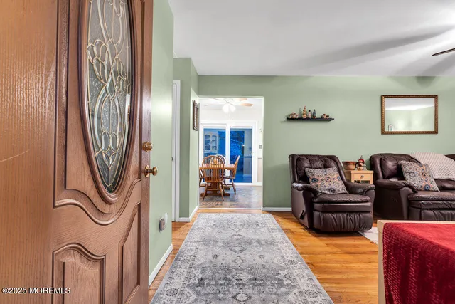 a living room with furniture and a chandelier