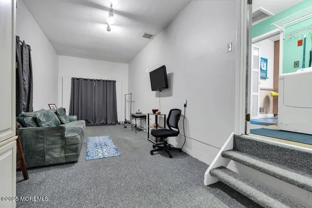 a view of a livingroom with workspace and a couch