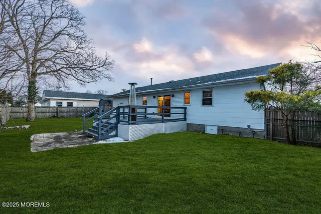 a view of a yard with table and chairs and a large tree