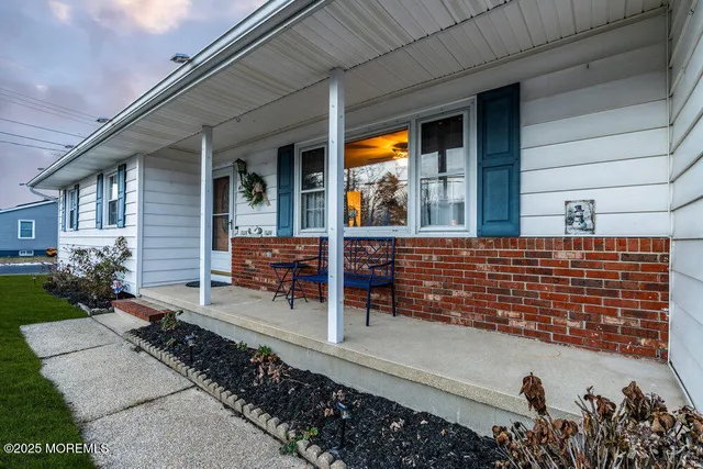 a backyard of a house with barbeque oven table and chairs