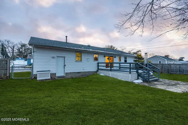 a backyard of a house with table and chairs