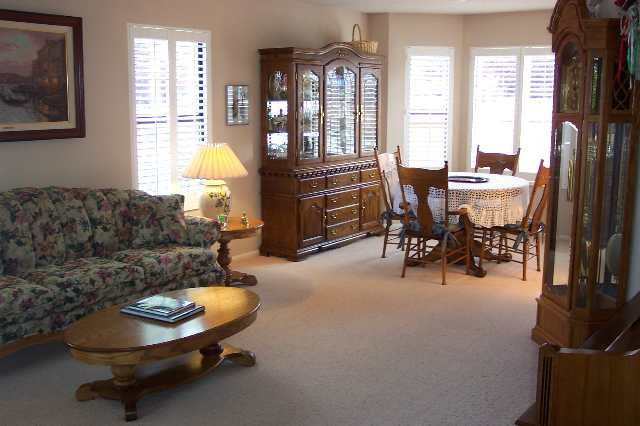 3108 Sweet Clover Street Reno, NV 89509 - Photo 5 of 7 a living room with furniture a table and a large window