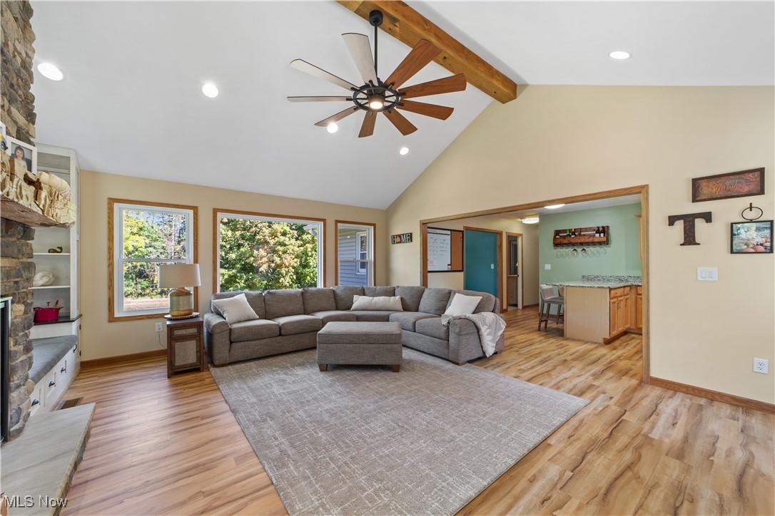 3694 Nichols Road Medina, OH 44256 - Photo 9 of 47 Living area featuring beamed ceiling, a ceiling fan, high vaulted ceiling, light wood-style floors, and recessed lighting