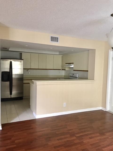 5321 Buckhead Circle Boca Raton, FL 33431 - Photo 11 of 35 a view of a kitchen with wooden floor and stainless steel appliances