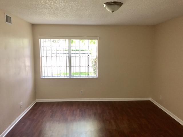 5321 Buckhead Circle Boca Raton, FL 33431 - Photo 15 of 35 an empty room with wooden floor and windows