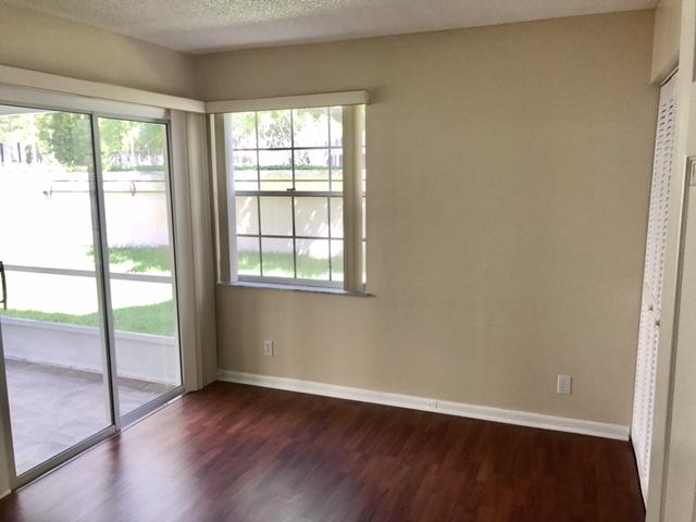 5321 Buckhead Circle Boca Raton, FL 33431 - Photo 17 of 35 an empty room with wooden floor and windows