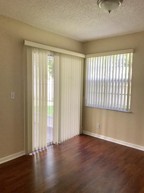 5321 Buckhead Circle Boca Raton, FL 33431 - Photo 18 of 35 an empty room with wooden floor and windows