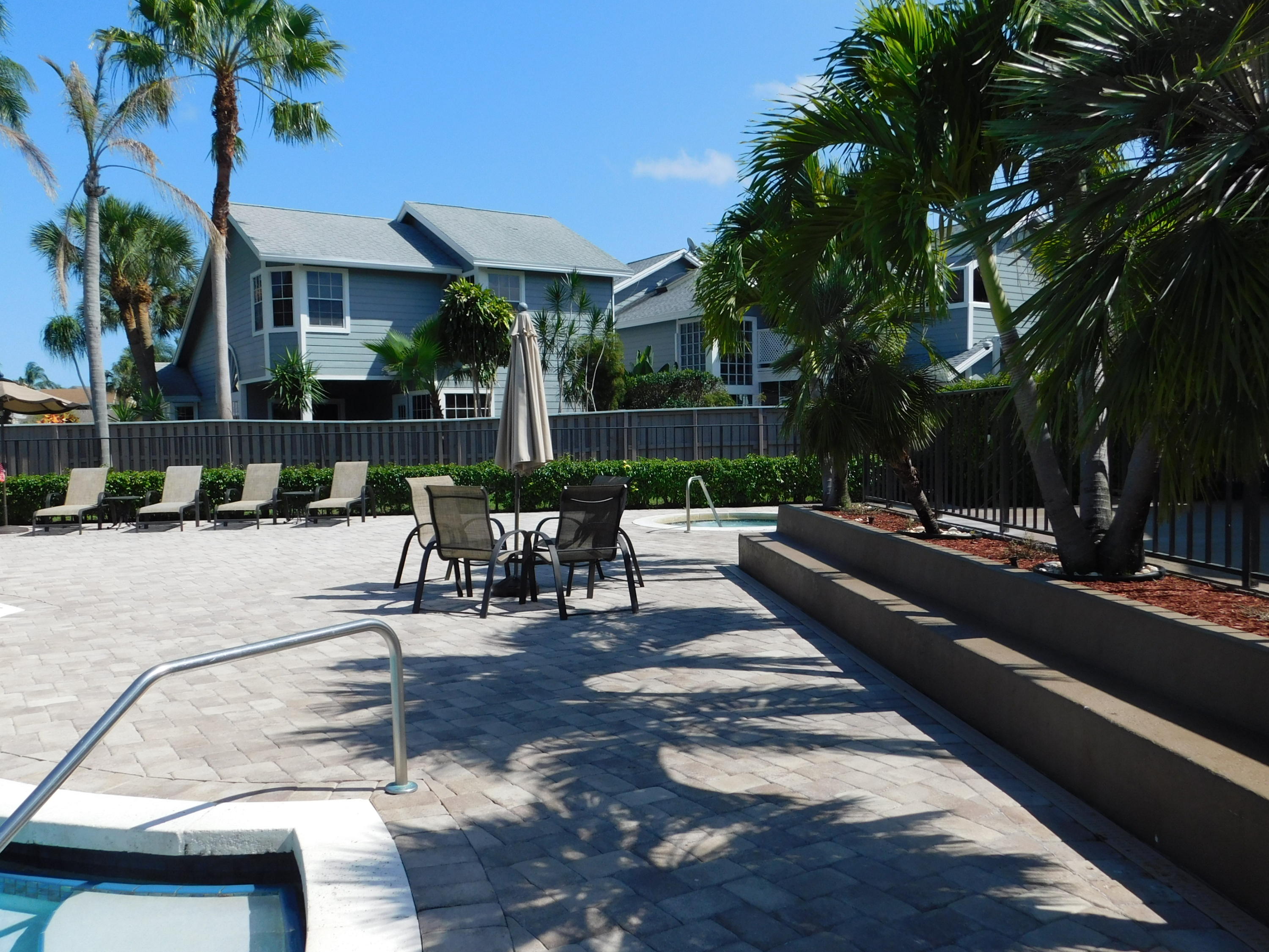 5321 Buckhead Circle Boca Raton, FL 33431 - Photo 31 of 35 a view of a patio with couches and table and chairs with wooden fence and plants