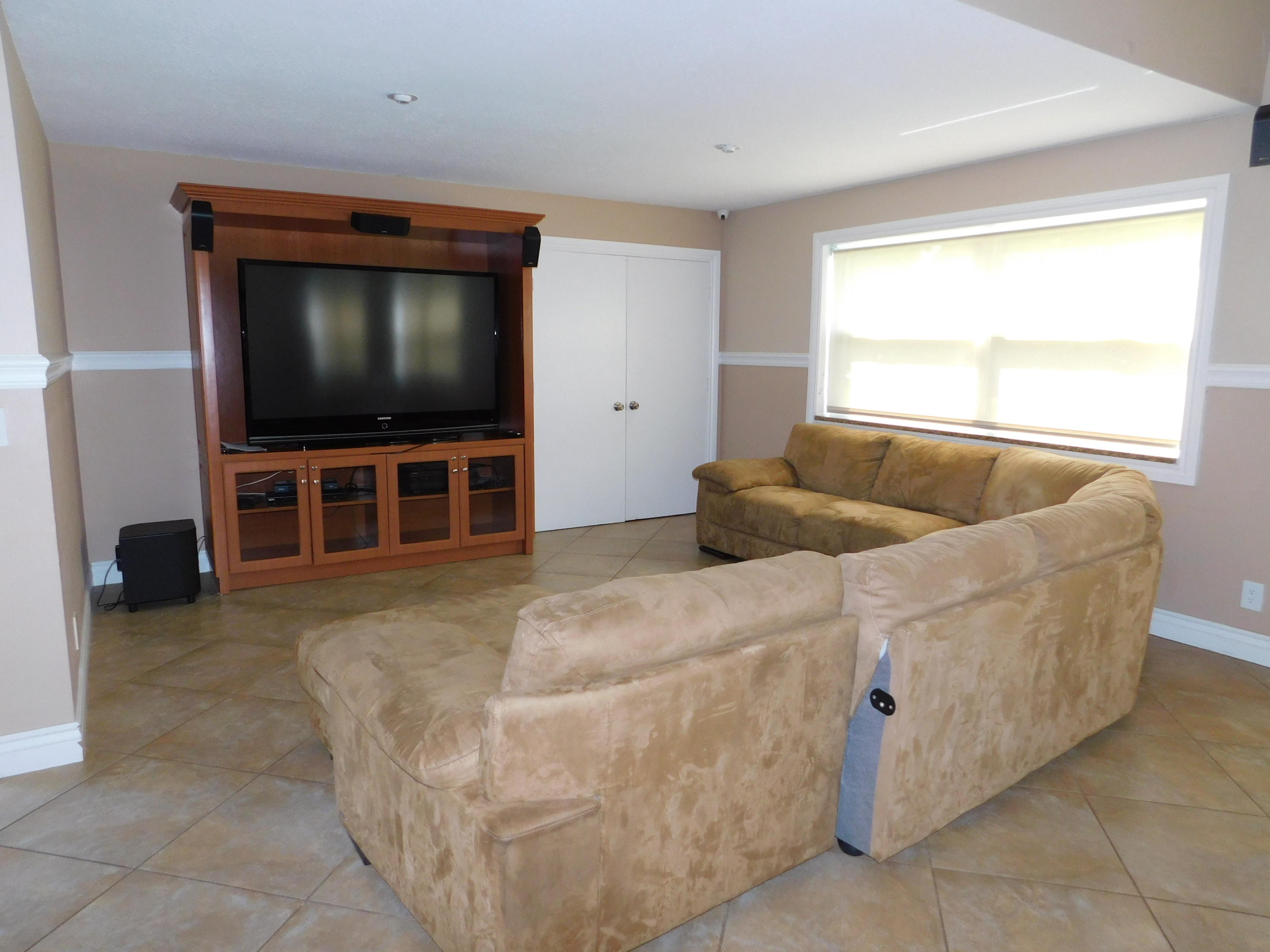 5321 Buckhead Circle Boca Raton, FL 33431 - Photo 33 of 35 a living room with furniture and a flat screen tv