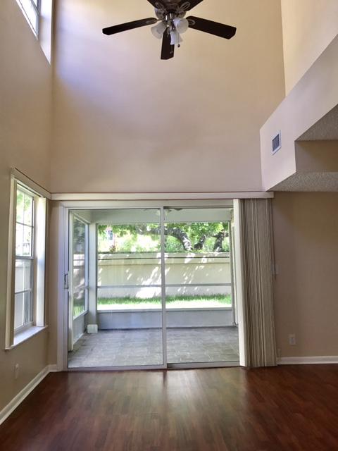 5321 Buckhead Circle Boca Raton, FL 33431 - Photo 6 of 35 an empty room with wooden floor and windows