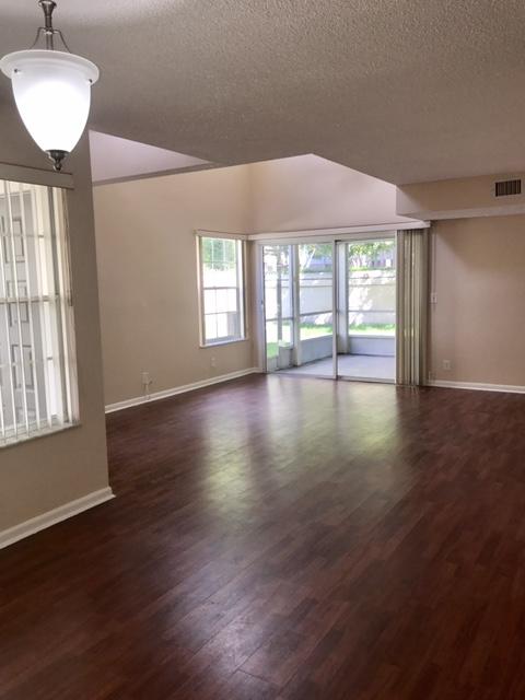 5321 Buckhead Circle Boca Raton, FL 33431 - Photo 7 of 35 a view of an empty room with wooden floor and a window