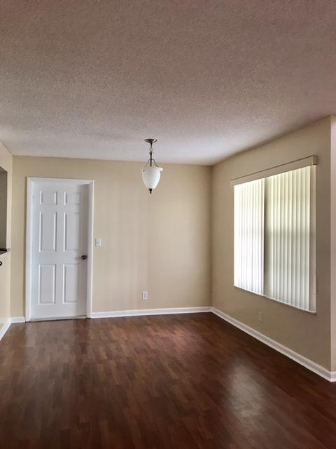 5321 Buckhead Circle Boca Raton, FL 33431 - Photo 8 of 35 an empty room with wooden floor and windows