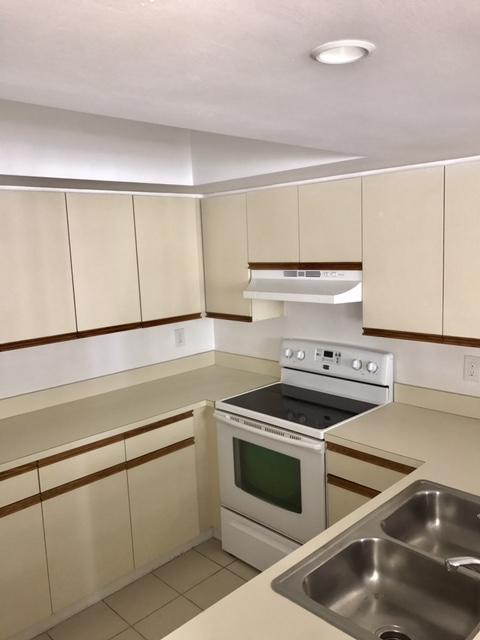 5321 Buckhead Circle Boca Raton, FL 33431 - Photo 10 of 35 a kitchen with white cabinets and appliances