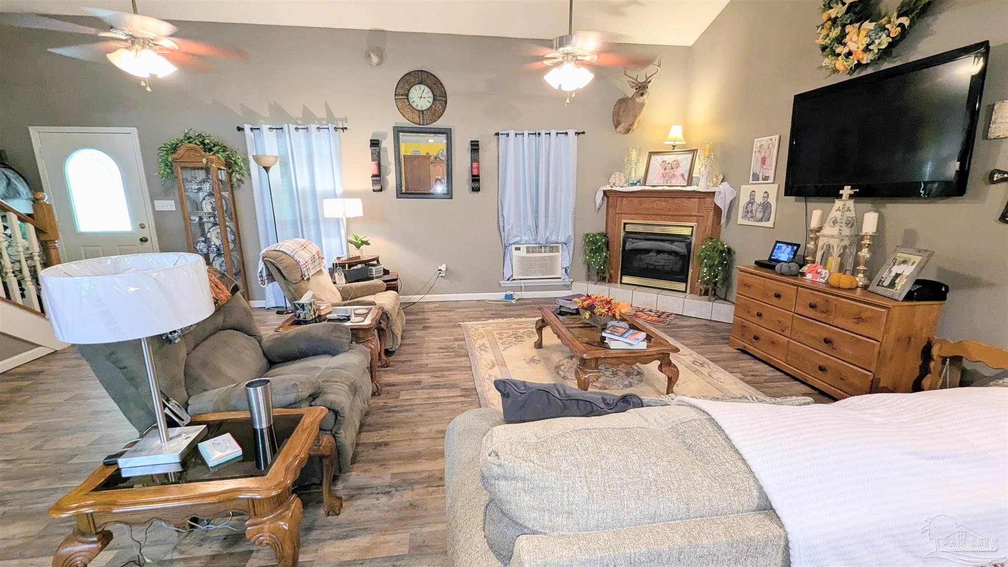 3171 Sam Sullivan Road Millry, AL 36558 - Photo 12 of 72 a living room with furniture a flat screen tv and kitchen view