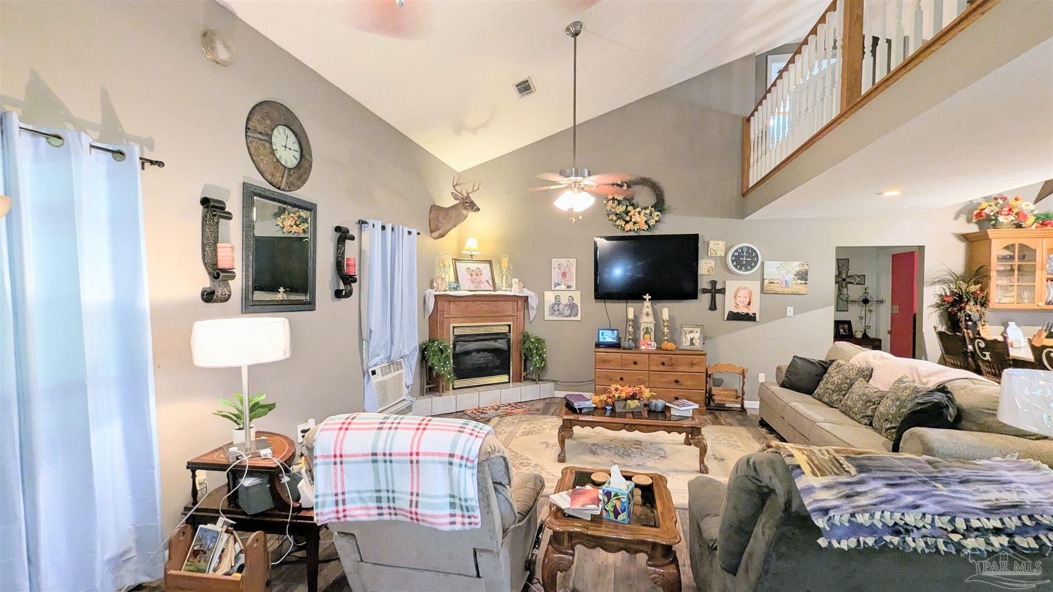 3171 Sam Sullivan Road Millry, AL 36558 - Photo 14 of 72 a living room with fireplace furniture and a flat screen tv