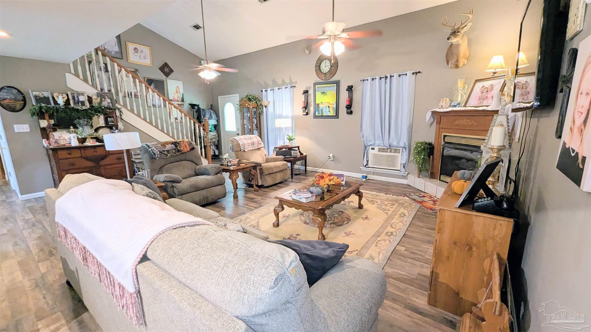 3171 Sam Sullivan Road Millry, AL 36558 - Photo 16 of 72 a living room with furniture a fireplace and a flat screen tv