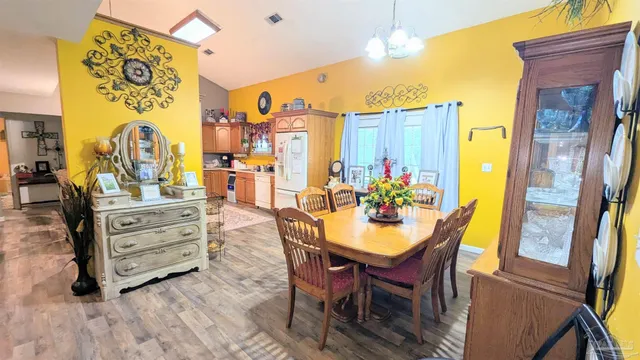 a view of a dining room with furniture and chandelier