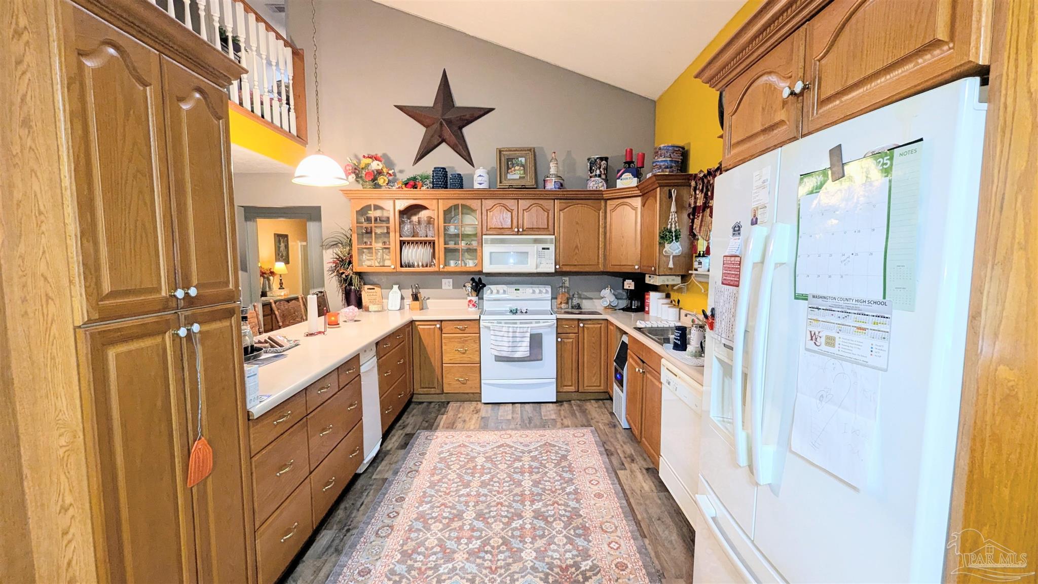 3171 Sam Sullivan Road Millry, AL 36558 - Photo 20 of 72 a kitchen with stainless steel appliances granite countertop a stove and a refrigerator
