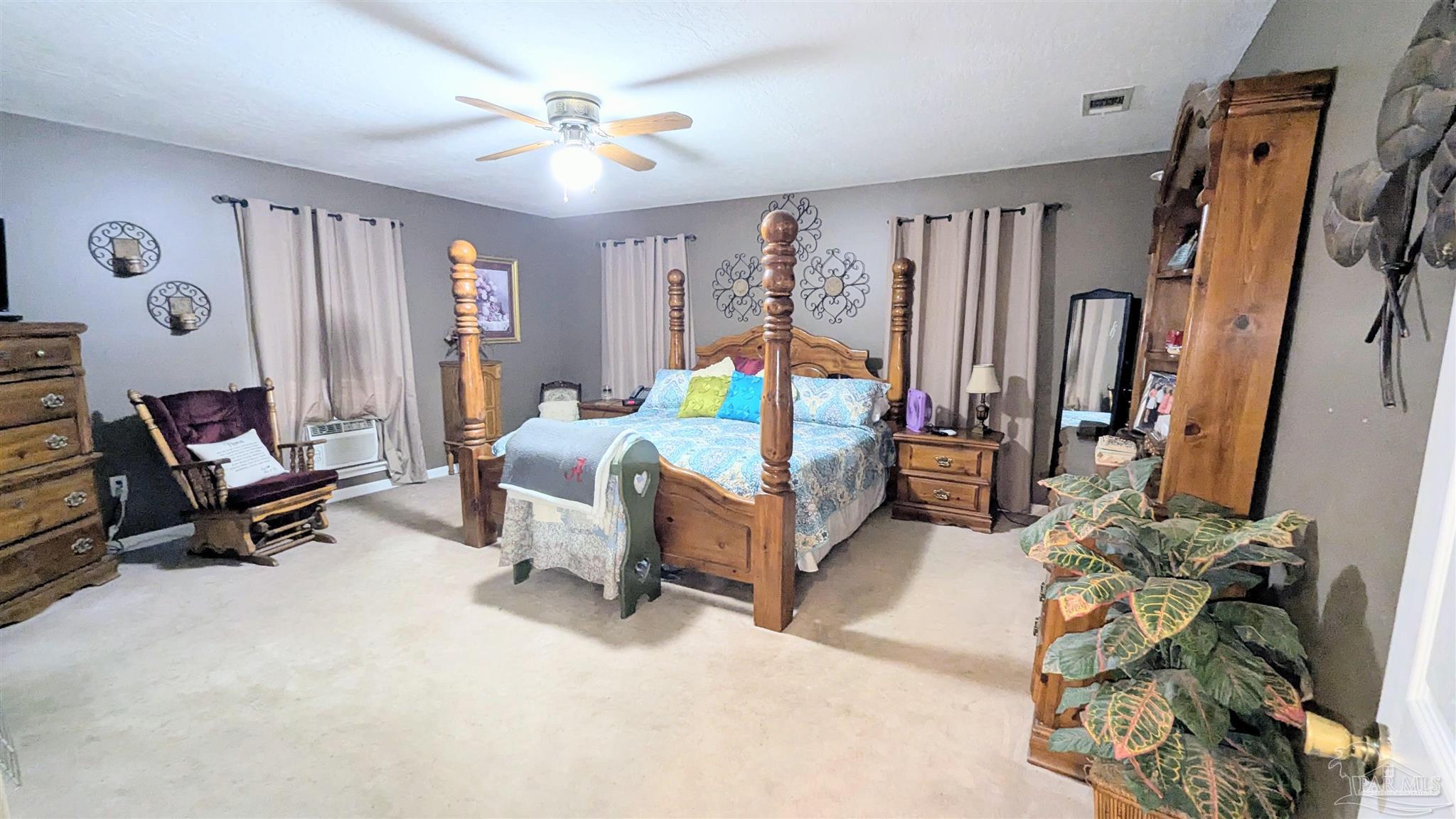 3171 Sam Sullivan Road Millry, AL 36558 - Photo 29 of 72 a bedroom with furniture and a gym equipment