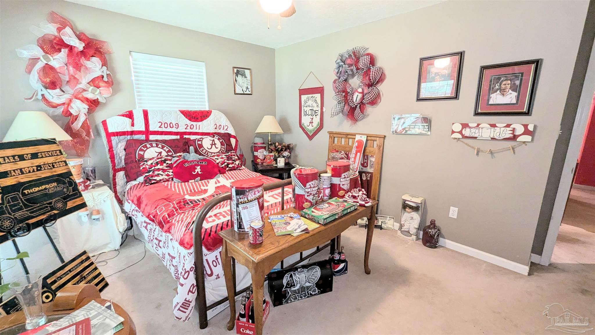 3171 Sam Sullivan Road Millry, AL 36558 - Photo 32 of 72 a bedroom with a bed and a table in it