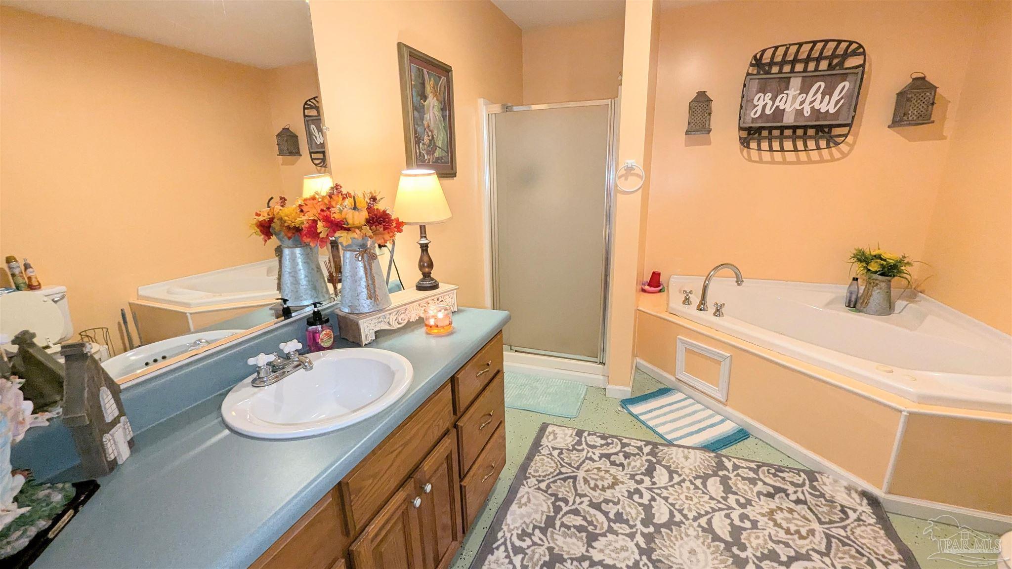3171 Sam Sullivan Road Millry, AL 36558 - Photo 35 of 72 a bath room with a sink and a mirror
