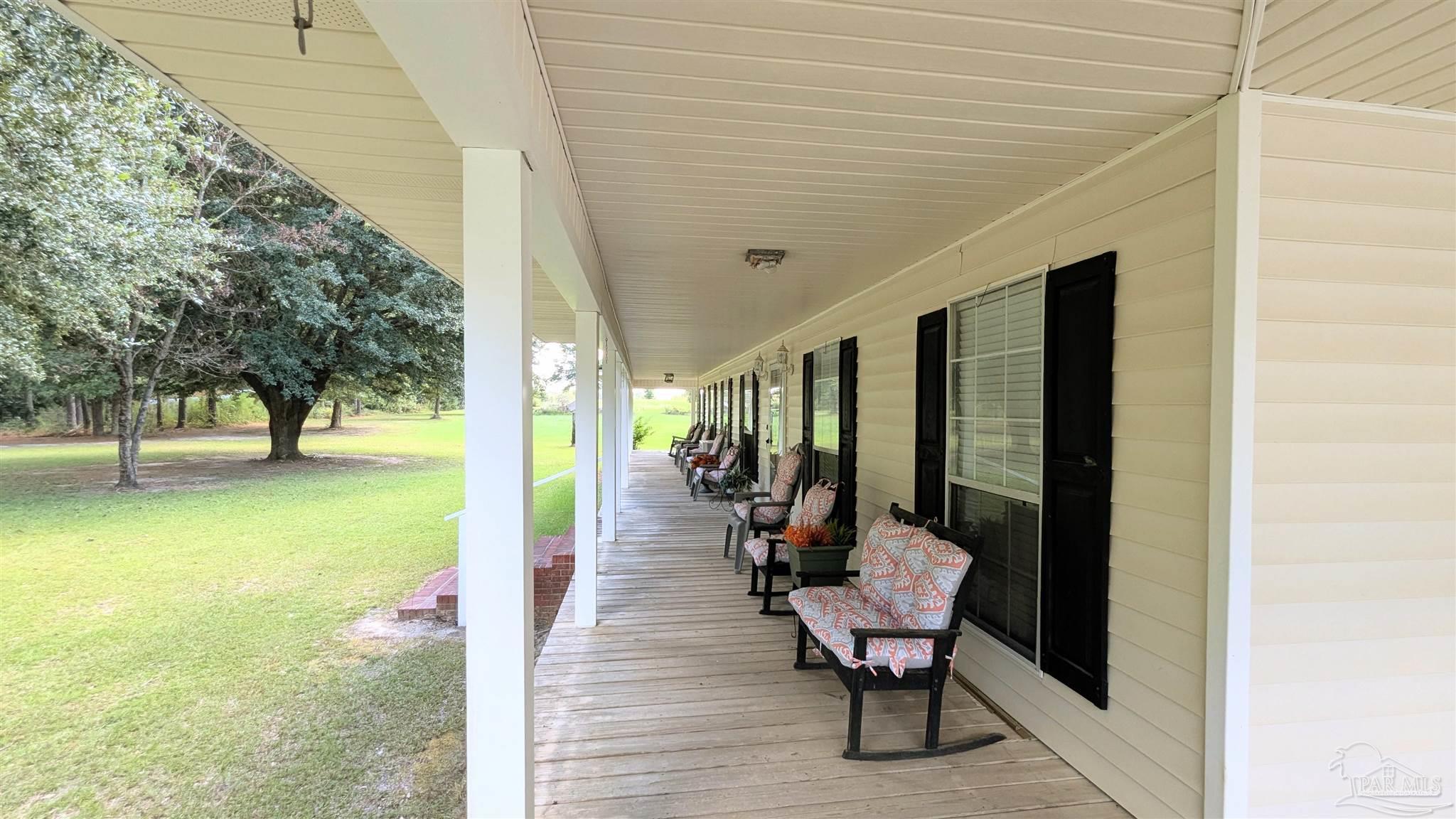 3171 Sam Sullivan Road Millry, AL 36558 - Photo 40 of 72 a view of a chairs and table in patio with a backyard