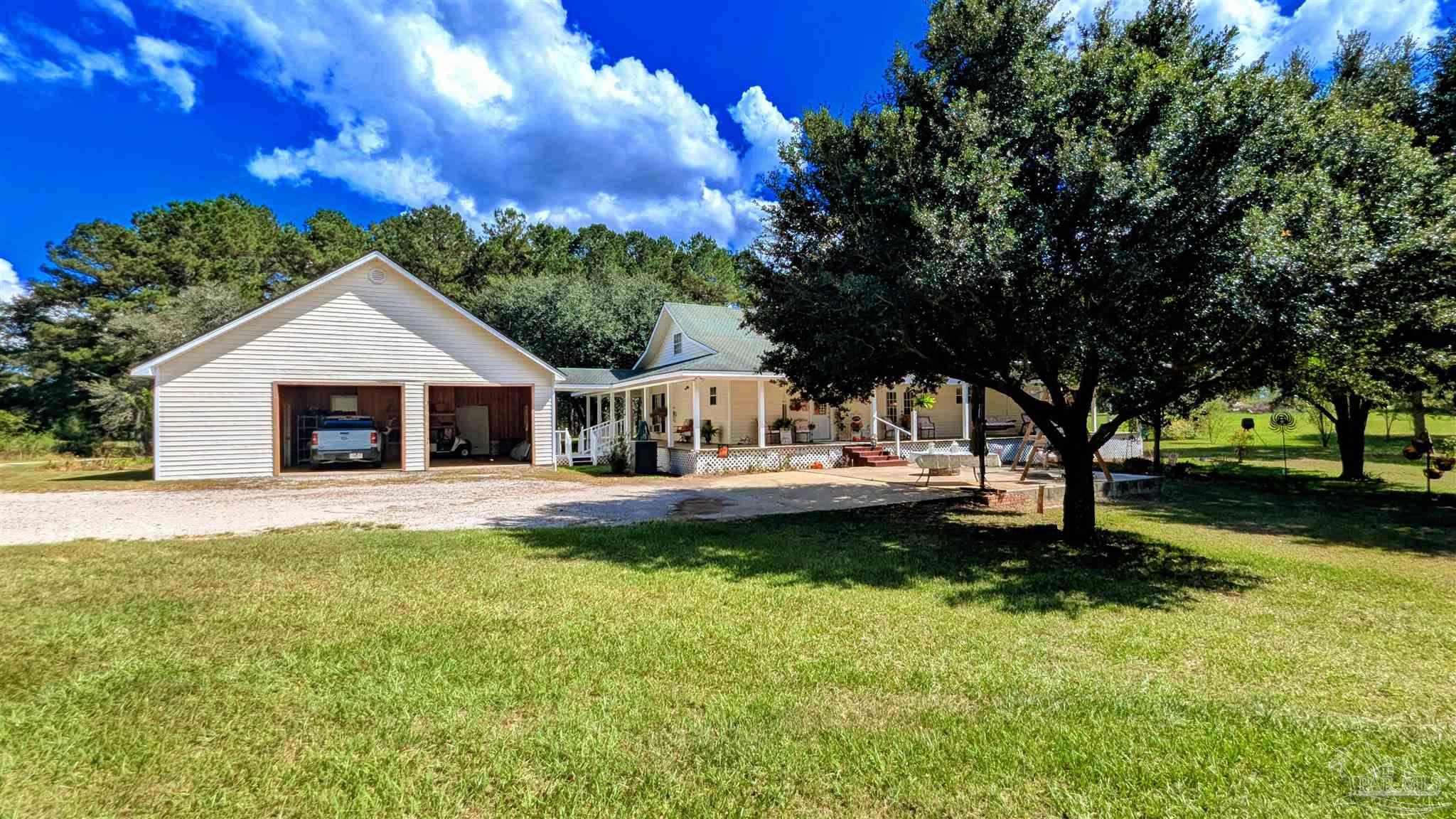 3171 Sam Sullivan Road Millry, AL 36558 - Photo 52 of 72 a front view of a house with a garden