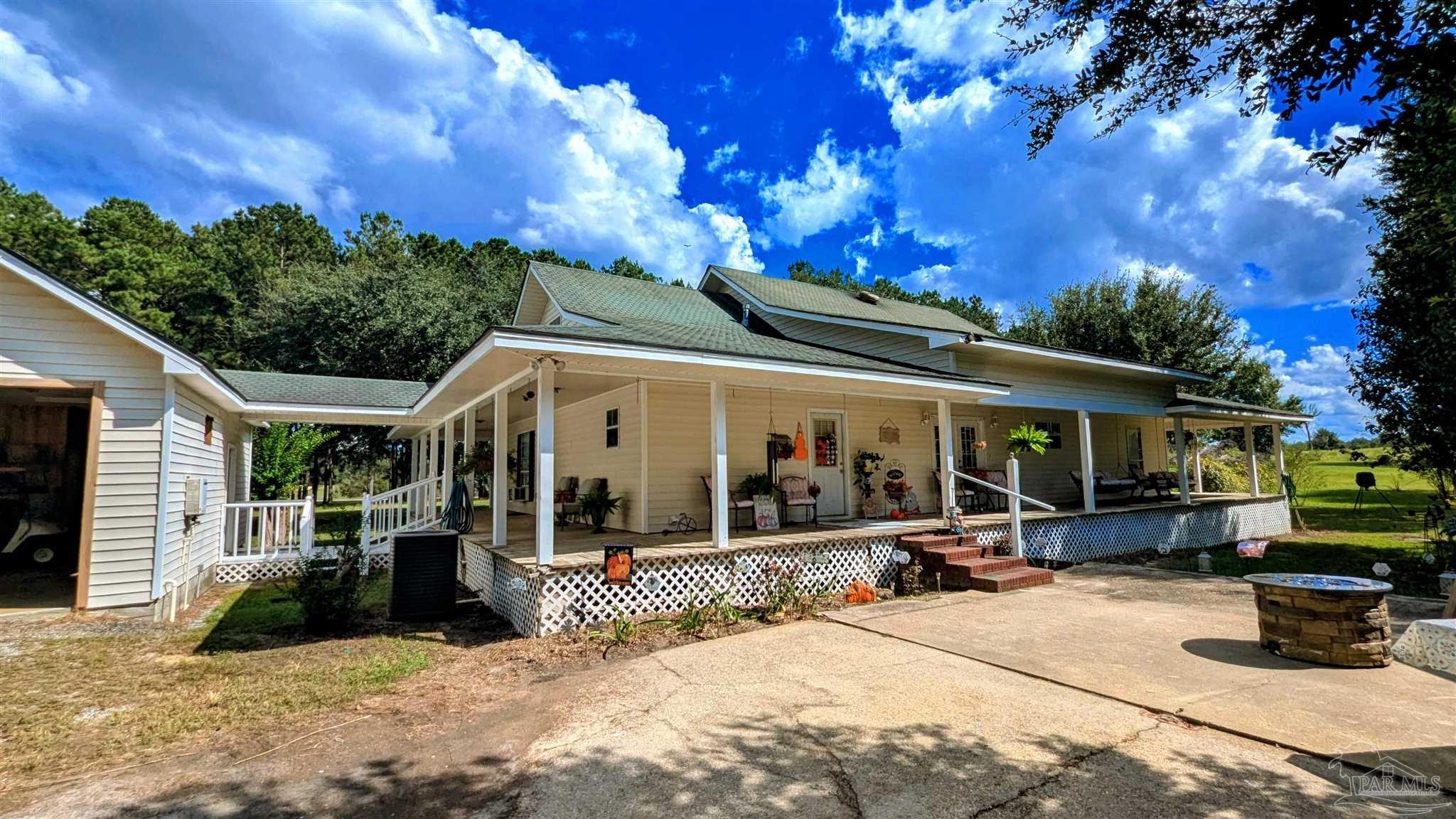 3171 Sam Sullivan Road Millry, AL 36558 - Photo 56 of 72 a view of a house with potted plants and a patio