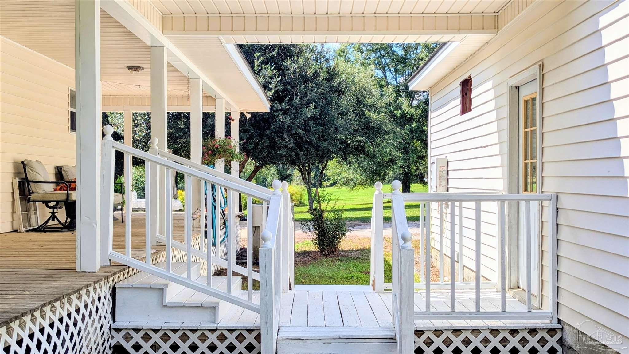 3171 Sam Sullivan Road Millry, AL 36558 - Photo 60 of 72 a view of a balcony with wooden floor and fence