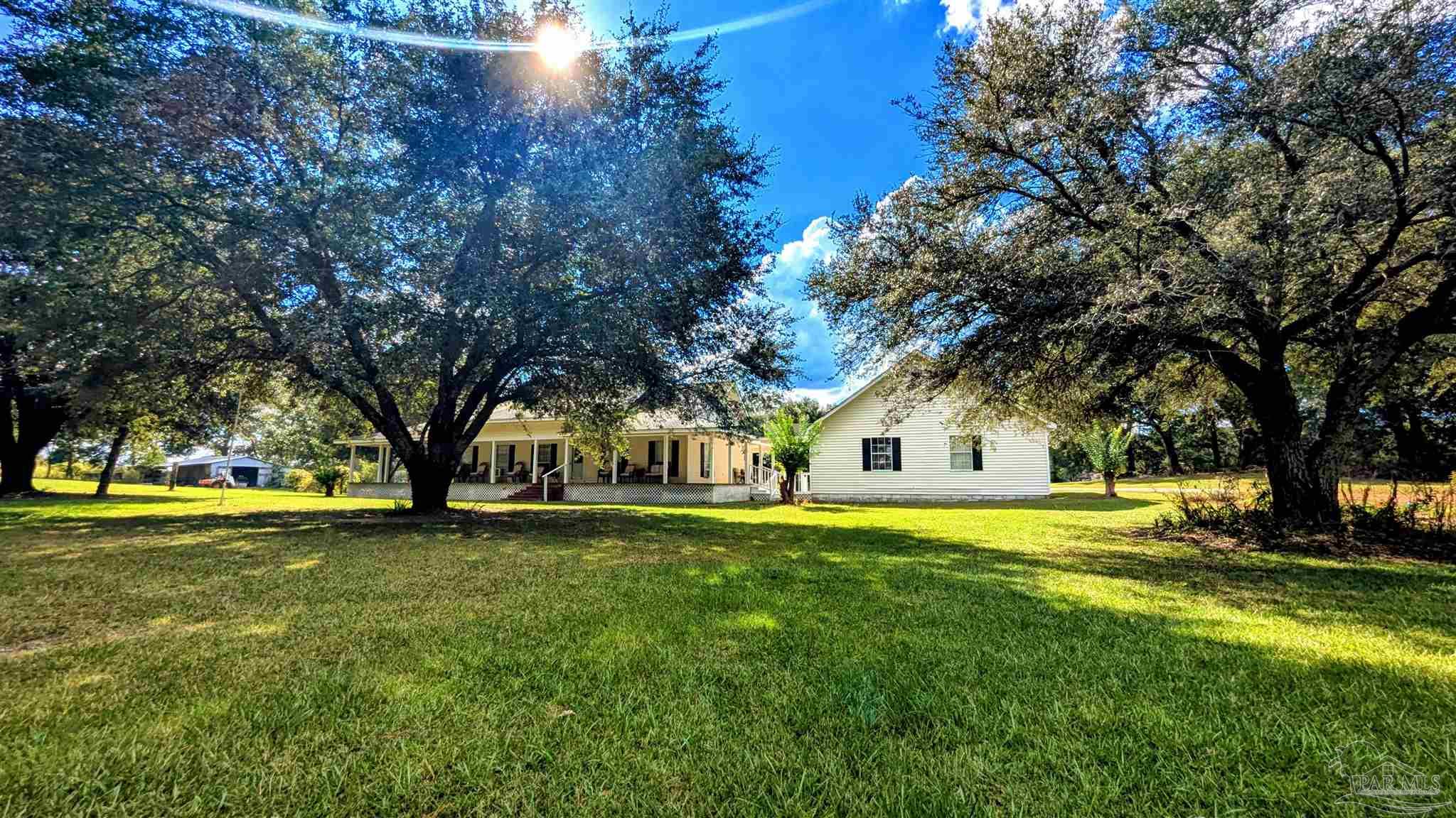 3171 Sam Sullivan Road Millry, AL 36558 - Photo 65 of 72 a front view of a house with a yard and trees