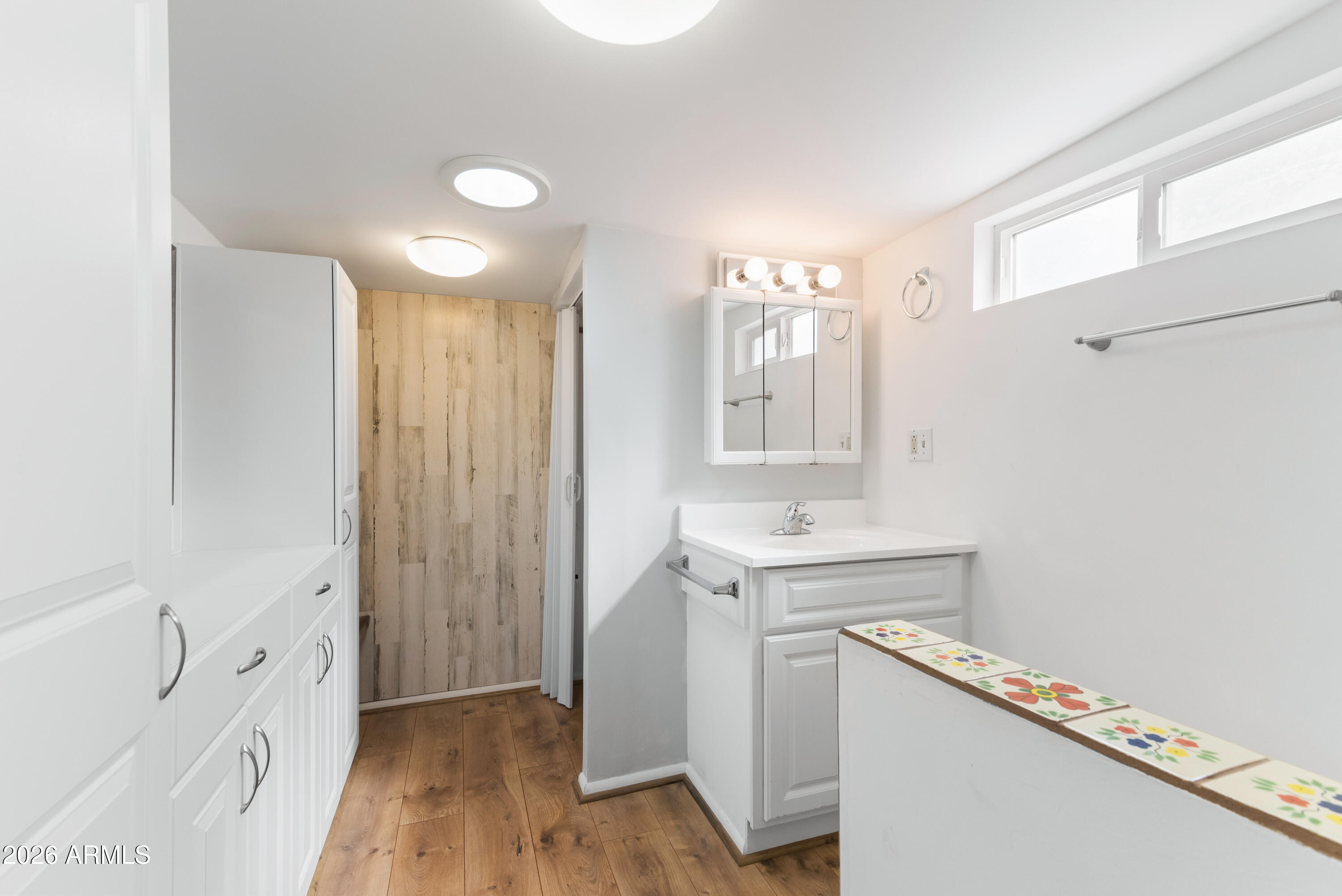 151 South Amulet Avenue Mesa, AZ 85208 - Photo 17 of 29 a bathroom with a sink a mirror and a shower