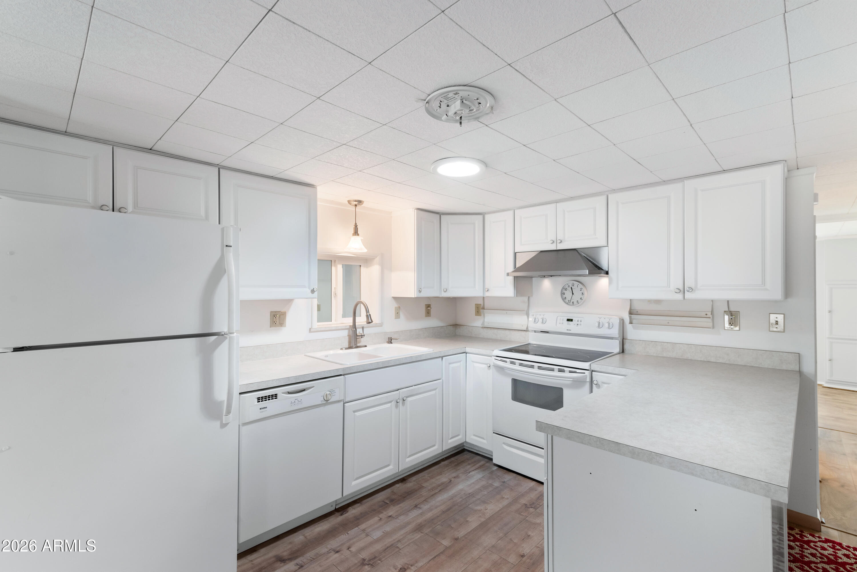 151 South Amulet Avenue Mesa, AZ 85208 - Photo 8 of 29 a kitchen with a sink a stove a refrigerator and white cabinets
