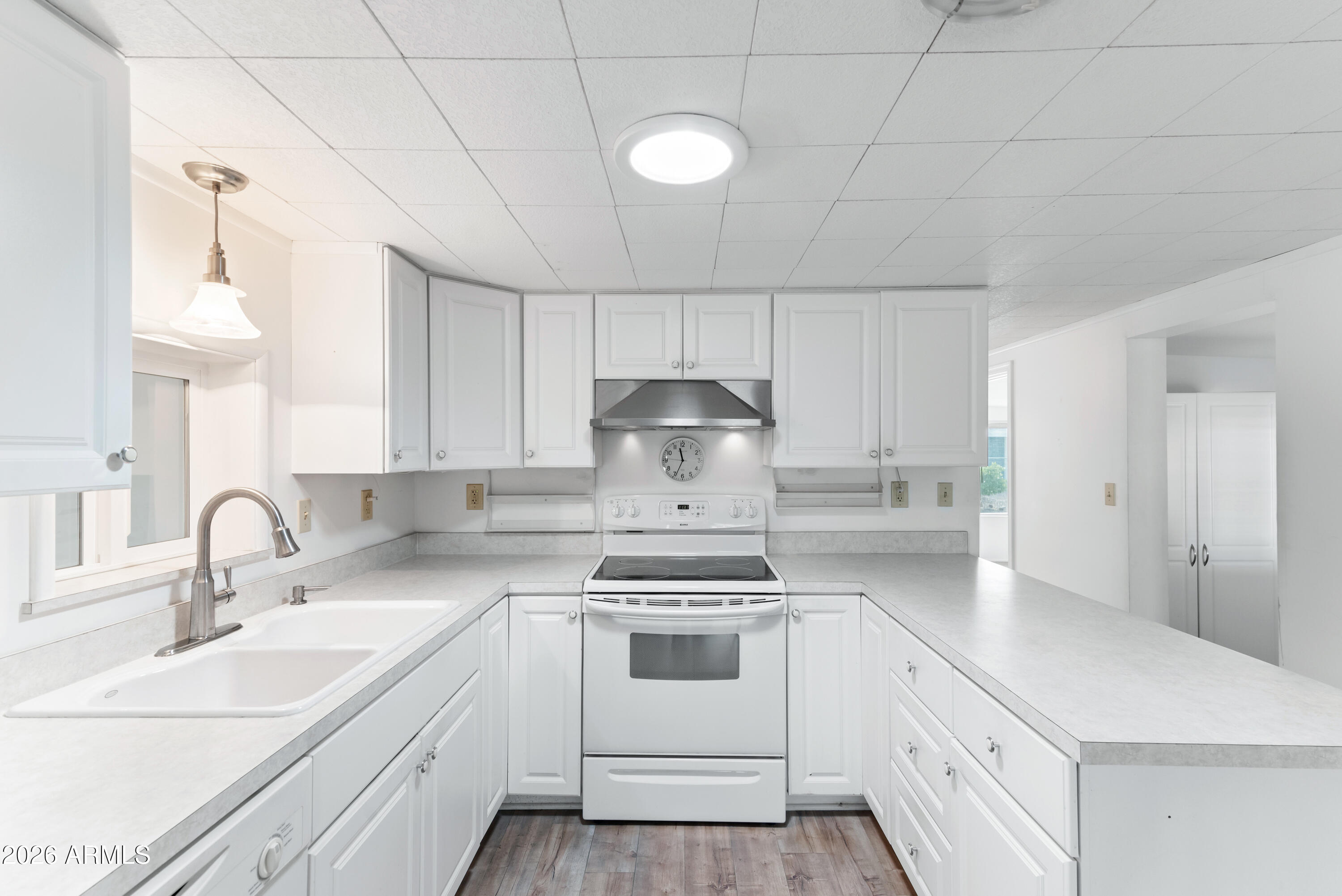 151 South Amulet Avenue Mesa, AZ 85208 - Photo 9 of 29 a kitchen with white cabinets stainless steel appliances and sink