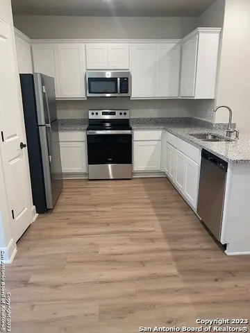 a kitchen with stainless steel appliances a refrigerator stove and sink