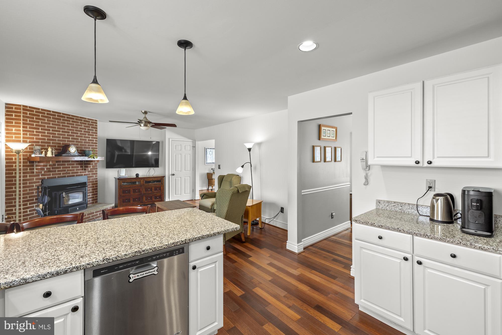 2300 Pin Oak Drive Finksburg, MD 21048 - Photo 11 of 52 a kitchen with stainless steel appliances granite countertop a sink a stove and a wooden floor