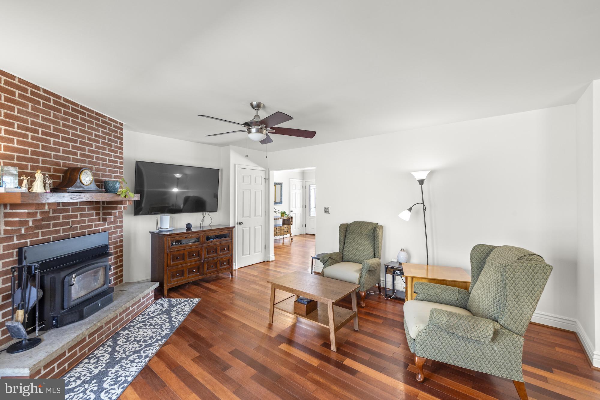 2300 Pin Oak Drive Finksburg, MD 21048 - Photo 13 of 52 a living room with furniture a fireplace and a flat screen tv