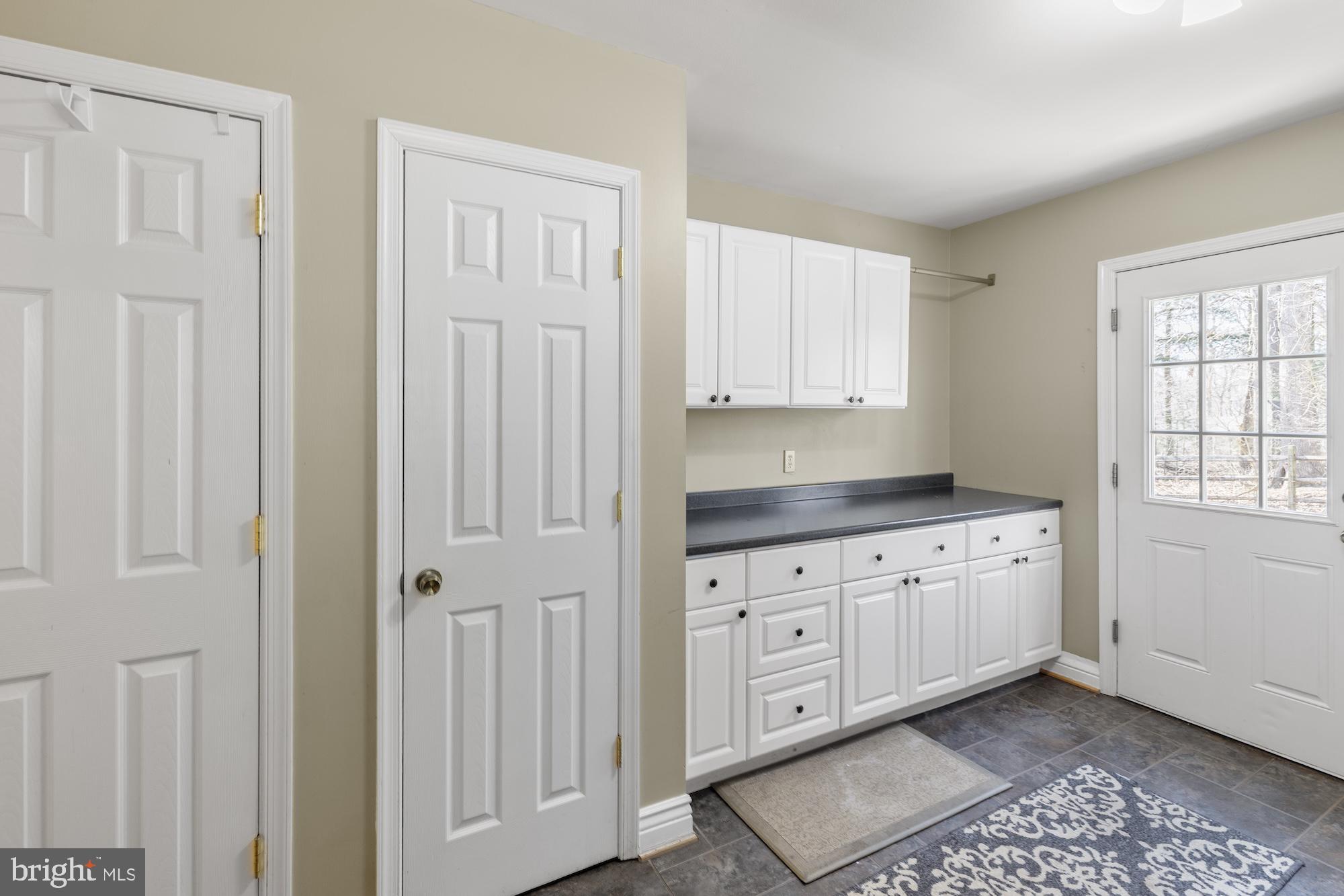 2300 Pin Oak Drive Finksburg, MD 21048 - Photo 19 of 52 a kitchen with granite countertop white cabinets and sink