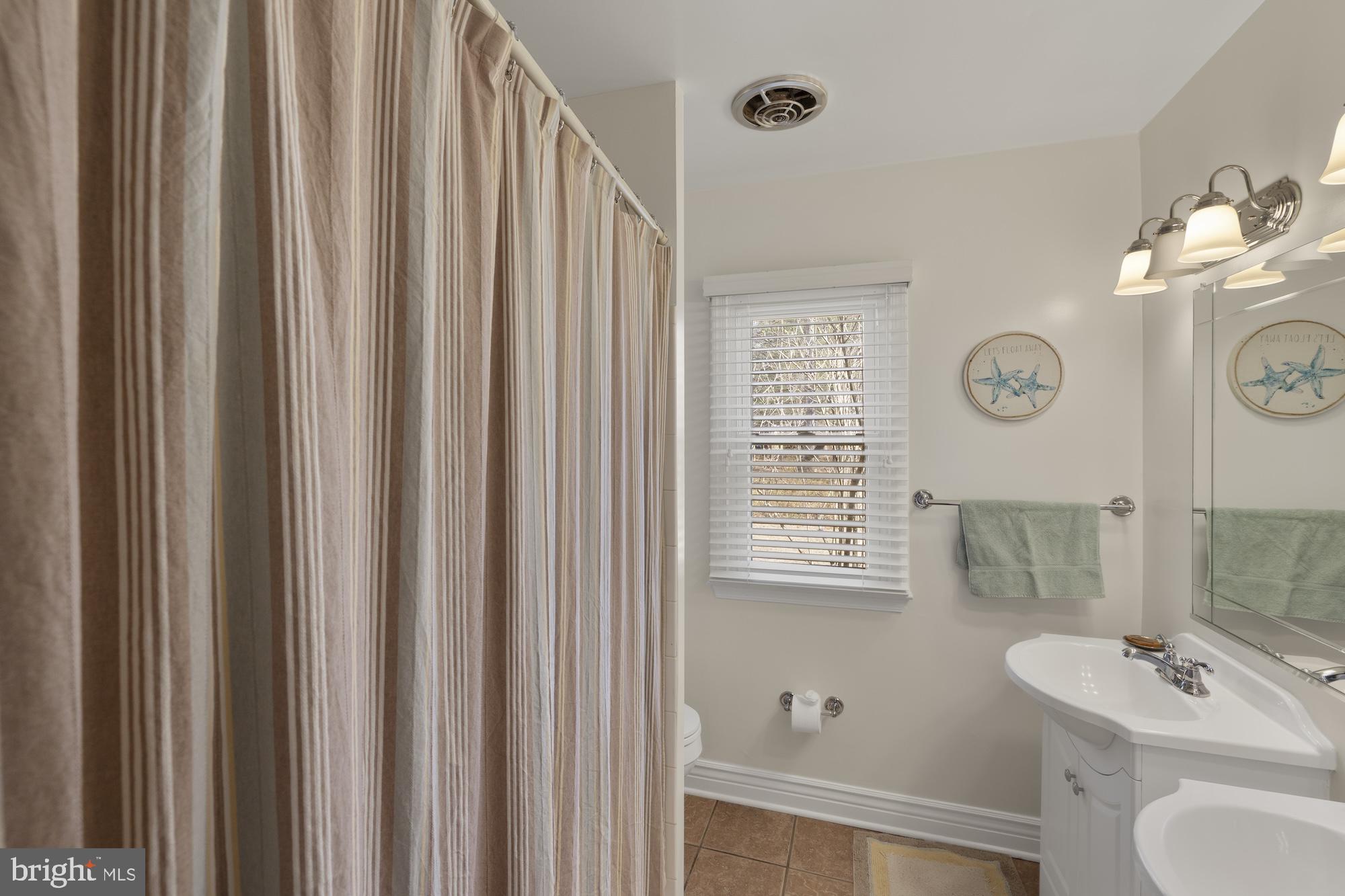 2300 Pin Oak Drive Finksburg, MD 21048 - Photo 32 of 52 a bathroom with a sink a toilet and a mirror