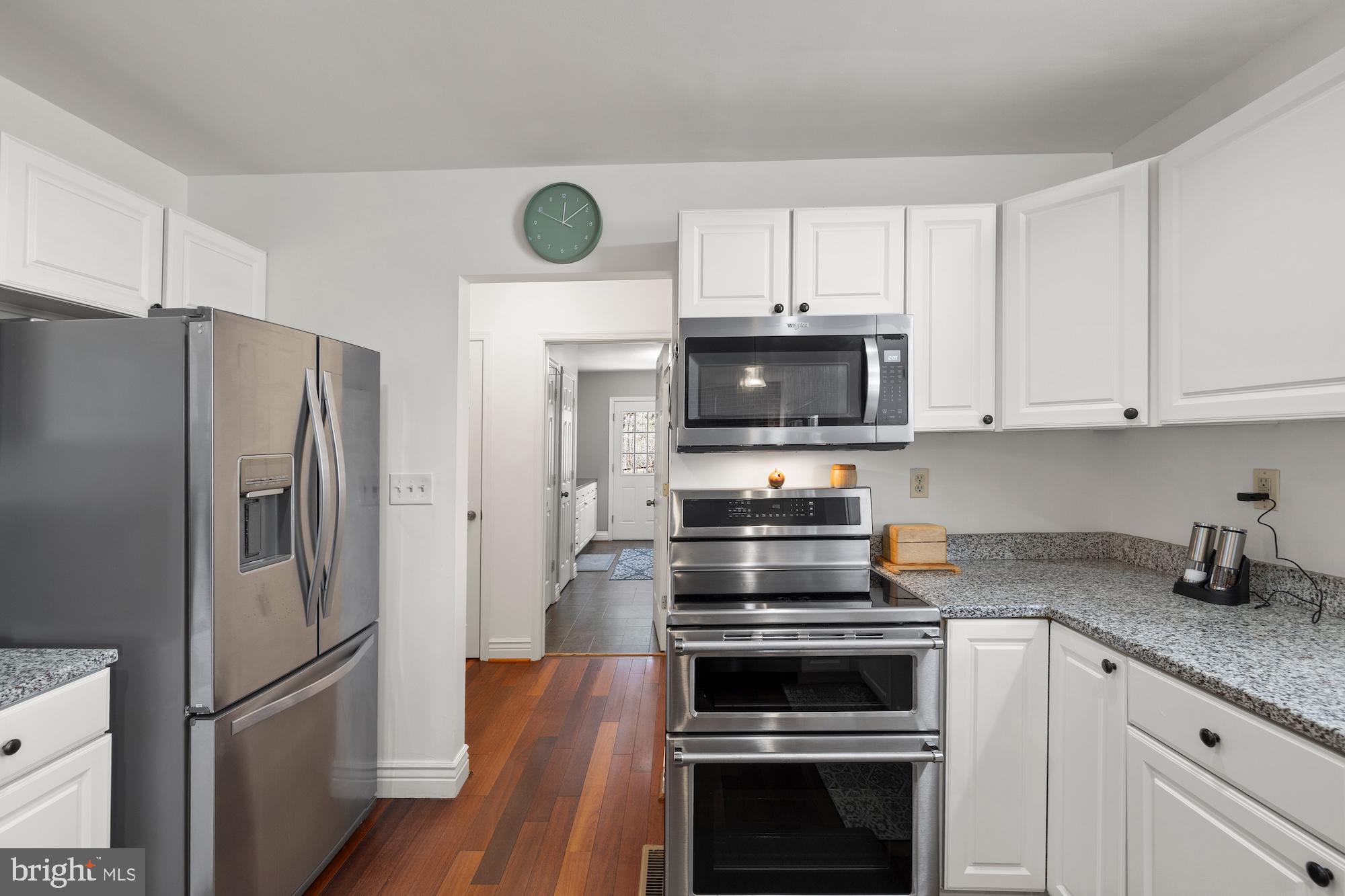 2300 Pin Oak Drive Finksburg, MD 21048 - Photo 8 of 52 a kitchen with cabinets stainless steel appliances and wooden floor