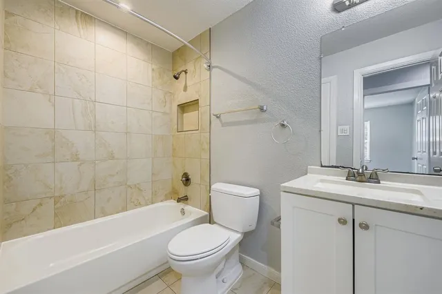 a bathroom with a sink a toilet and a bathtub