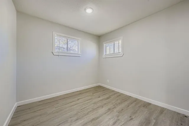 a view of a room with wooden floor and window