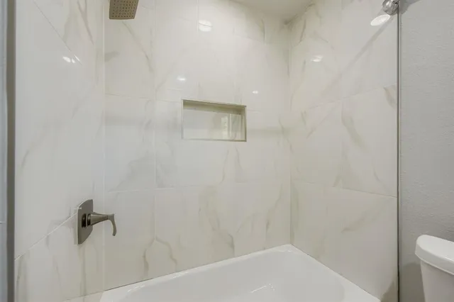 a bathroom with a shower and a toilet